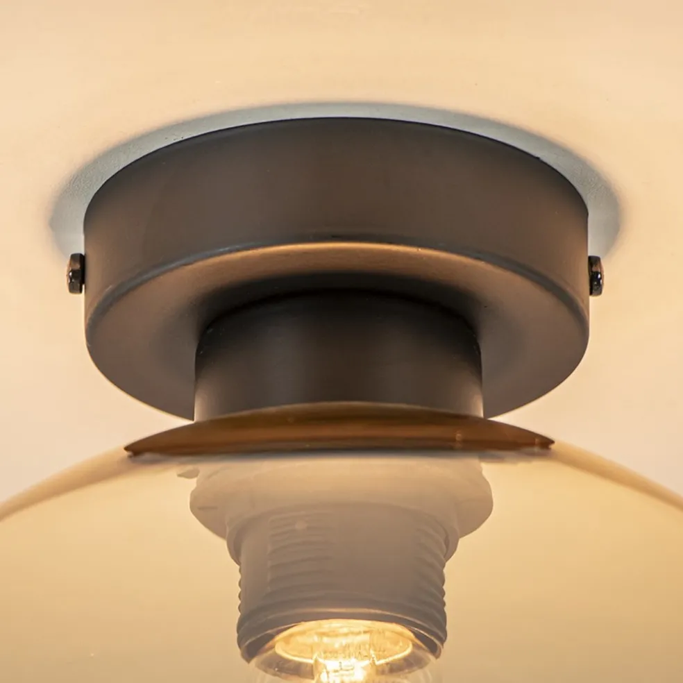 Mat zwarte plafondlamp met amber glazen bol