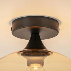 Mat zwarte plafondlamp met amber glazen bol 30 cm